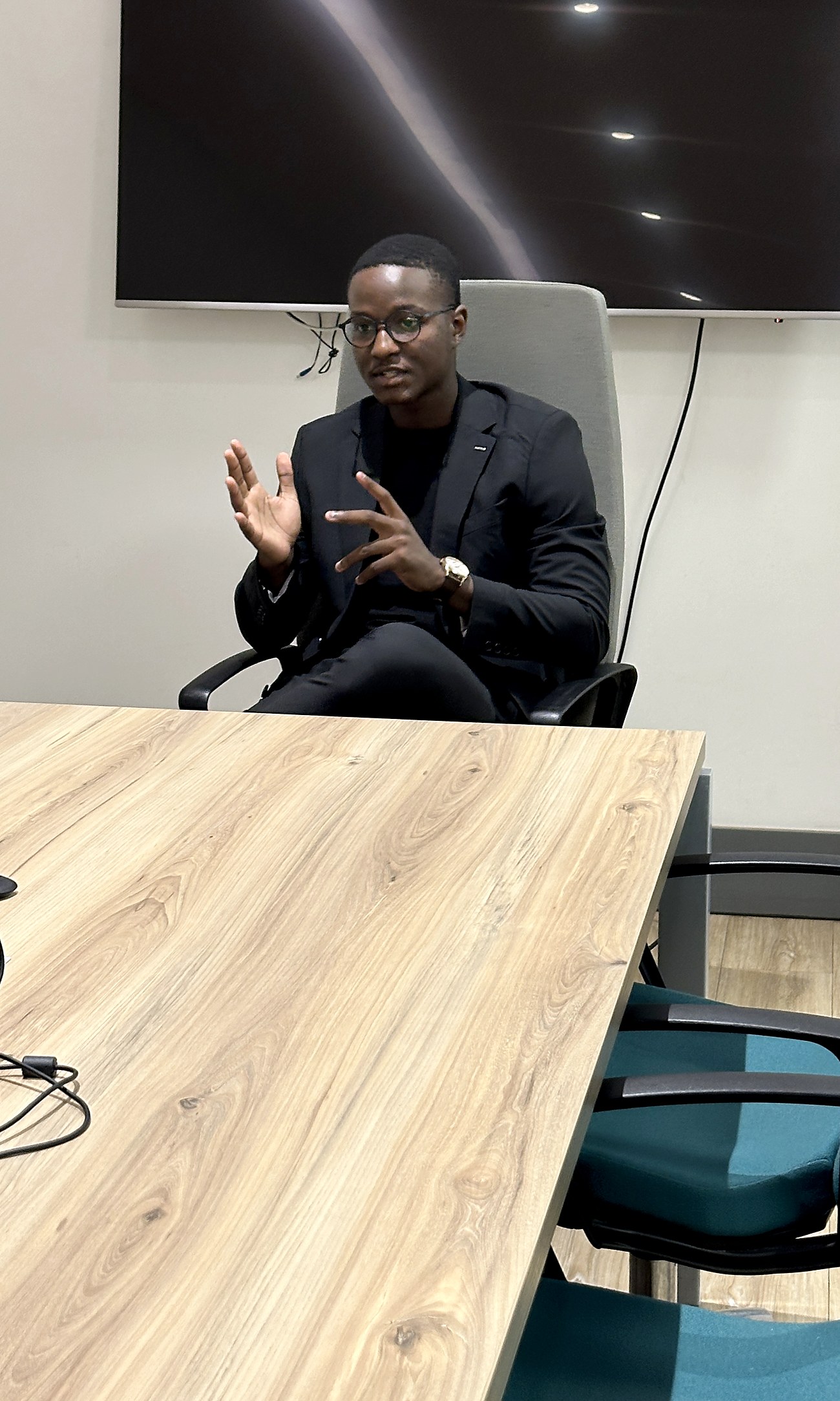 Tapuwa, founder of Justech AI, mid-session at a boardroom table in Cape Town